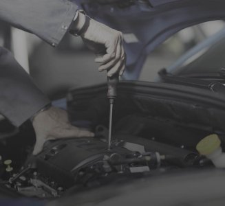 two hands working on car in automotive industry