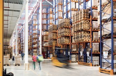 Busy logistics work environment with a truck high shelves and lots of pallets