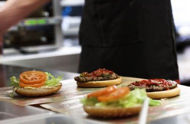 Burger King burgers being freshly assembled on a preparation table