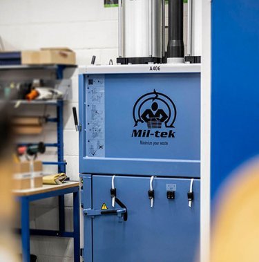 How does a cardboard baler work