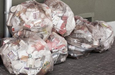 clear bags with mixed waste on floor