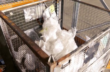 plastic waste from automotive parts in cage