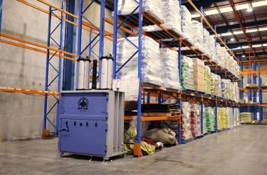 baler placed at end of aisle at warehouse