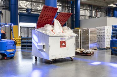 container in logistics facility filled with plastic waste