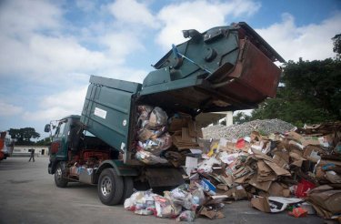 truck unloading cardboard on the ground