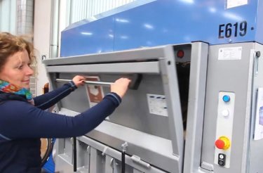 woman opens electric baler